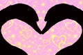 Valentines day concept, silhouette of two swan heads forming a heart shape together, on a pink background with golden