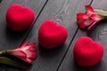 Valentines day concept. Three Red heart velvet cakes on a wooden black background with a delicate Alstroemeria flowers Royalty Free Stock Photo