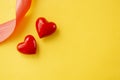Valentines day concept. Two red hearts on yellow background. Copy space Royalty Free Stock Photo