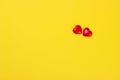 Valentines day concept two red hearts on yellow background. Royalty Free Stock Photo