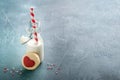 Valentines day cookies. Shortbread cookies inside sweet red heart on pink plate and bottle of milkshake on dark blue background. Royalty Free Stock Photo