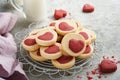 Valentines day cookies. Shortbread cookies inside a sweet red heart on pink plate on grey background. Mothers day. Womans day. Swe Royalty Free Stock Photo