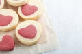 Valentines day cookies. Shortbread cookies inside a sweet red heart on parchment paper on white background. Mothers day. Womans Royalty Free Stock Photo