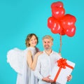 Valentines Day. Couple of Cupids angels with red heart shaped balloons and gift box.