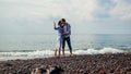 Valentines day. Couple in love kissing on honeymoon in Santorini island, Greece. People walking on beach by sea Royalty Free Stock Photo