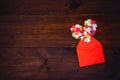 Valentines day creativity, DIY gift, card ideas. Many multicolored paper hearts with red paper envelope on wooden background