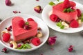 Valentines day dessert. heart shaped raw vegan red cakes with raspberries, dried rose flowers and mint. healthy food Royalty Free Stock Photo