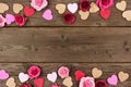 Valentines Day double border of hearts and roses against rustic wood