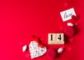 Valentines Day. February 14 wooden calendar, greeting card with the inscription love, red hearts, flowers on a red background. Top Royalty Free Stock Photo