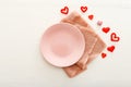 Valentines Day festive table setting on a white wooden table. Dinner meal in restaurant at Valentine Day. Many red hearts, pink Royalty Free Stock Photo