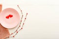 Valentines Day festive table setting on a white wooden table. Dinner meal in restaurant at Valentine Day. Two red hearts on pink Royalty Free Stock Photo