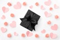 Valentines day floral background with coral or pink flowers, coral paper hearts, black gift box flat lay. Mothers day, Women day.