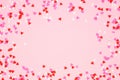 Valentines Day frame with candy heart sprinkles over a pink background with copy space Royalty Free Stock Photo