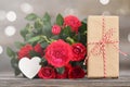 Valentines Day gift and bunch of red roses. Mothers Day gift and flowers