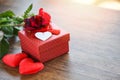 Valentines day gift box flower love concept Red gift box with ribbon bow red roses flower and heart Royalty Free Stock Photo