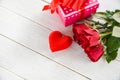 Valentines day gift box pink on white table background / Romantic red heart valentines red roses Royalty Free Stock Photo