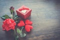 Valentines day gift box red on wood Red Heart Valentines day red rose flower and present box ribbon bow on old wooden Royalty Free Stock Photo