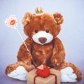 Valentines Day Teddy bear holding heart with text love and gift box. Retro romantic style. Creative greeting card Royalty Free Stock Photo