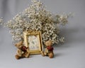 Valentines day gift idea. Golden photo frame and figurines of teddy bears with red bouquets. Cute present