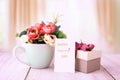 Valentines day greeting card. Birthday gift box with flowers on wooden table over bright blurred curtain background. Holidays, Royalty Free Stock Photo