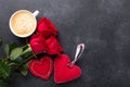 Valentines day greeting card. Coffee cup, red roses and textile hearts on stone background. Top view Royalty Free Stock Photo