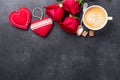 Valentines day greeting card. Coffee cup, red roses and textile hearts on stone background. Top view Royalty Free Stock Photo