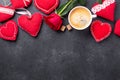 Valentines day greeting card. Coffee cup, red roses and textile hearts on stone background. Top view Royalty Free Stock Photo