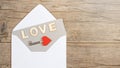 Valentines day greeting card concept banner. Envelope and old key with red hearts on rustic wooden wood table texture background Royalty Free Stock Photo