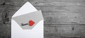 Valentines day greeting card concept. Envelope, card with text, LOVE and key with red hearts on rustic gray black vintage wooden Royalty Free Stock Photo