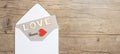 Valentines day greeting card concept. Envelope, card with text, LOVE and key with red hearts on rustic  vintage wooden wood table Royalty Free Stock Photo