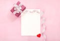 Valentines day greeting card with pink gift box white bow long curved ribbon and paper red heart