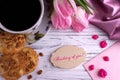 Valentines day greeting card with pink tulips coffe cup cookies and lettering thinking of you.