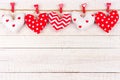 Valentines Day handmade cloth heart pillows on a line over white wood Royalty Free Stock Photo