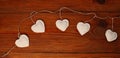 Valentines Day header design, website banner flat lay.Eco linen hearts garland on wooden background.Advertising template