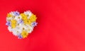 Valentines Day heart made of beautiful flowers isolated on red background.e of postcard
