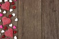 Valentines Day heart shaped candy side border on rustic wood