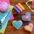 Valentines day hearts. Bright felt heart ornaments, scissors, thread set, pincushion, needles, thimble, felt sheets