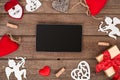 Valentines day hearts, ring, gift box and the tablet over wooden background. Royalty Free Stock Photo