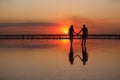 Valentines day. Heterosexual couple in love, silhouette of romantic young man and woman holding hands enjoying sea Royalty Free Stock Photo