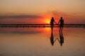 Valentines day. Heterosexual couple in love, silhouette of romantic young man and woman holding hands enjoying sea Royalty Free Stock Photo