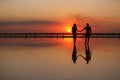 Valentines day. Heterosexual couple in love, silhouette of romantic young man and woman holding hands enjoying sea Royalty Free Stock Photo