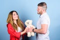 Valentines day holiday. Surprise for sweetheart. Soft toy teddy bear gift. Man and woman couple in love. Romantic