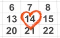 Valentines day and Holidays concept - Calendar sheet with 14th february date marked by red heart shape. Close up Royalty Free Stock Photo