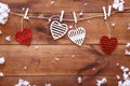 Valentines day love background, red white decorative hearts hanging on brown wooden table with snow falling, happy romantic Royalty Free Stock Photo