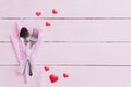 Valentines day and love concept. Fork and spoon with red hearts on pink pastel wooden background Royalty Free Stock Photo
