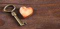 Valentines day, love concept, heart with key on a wooden background Royalty Free Stock Photo