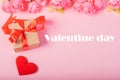 Valentines day and love concept. One small gift box with red heart and flowers on pink background Royalty Free Stock Photo