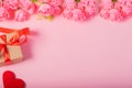 Valentines day and love concept. One small gift box with red heart and flowers on pink background Royalty Free Stock Photo