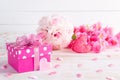 Valentines day and love concept. Pink gift box with handmade red heart and flowers on wooden block on white wooden background Royalty Free Stock Photo