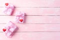 Valentines day and love concept. Pink gift box with red heart and flowers on pink wooden background Royalty Free Stock Photo